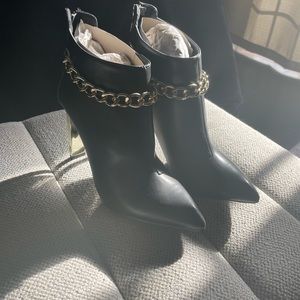Black and gold ankle high boots with gold chain trim